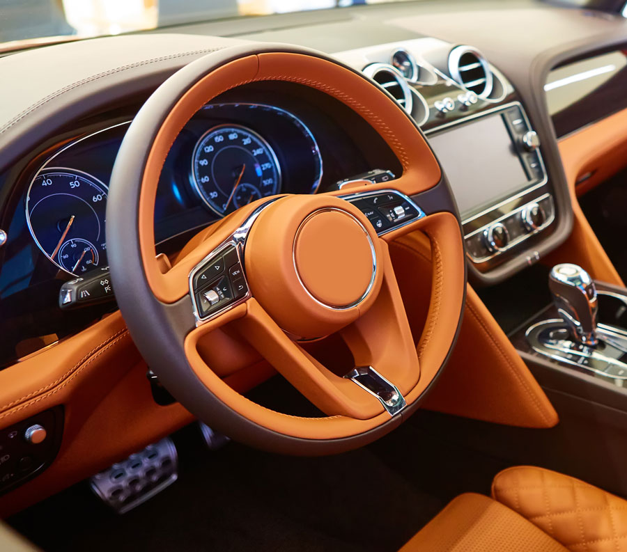 Luxurious leather interior, impeccably cleaned with diamond-stitched detailing and ambient lighting.